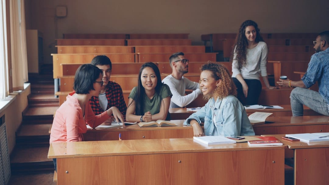 Diverse teens learning together in a bright modern classroom