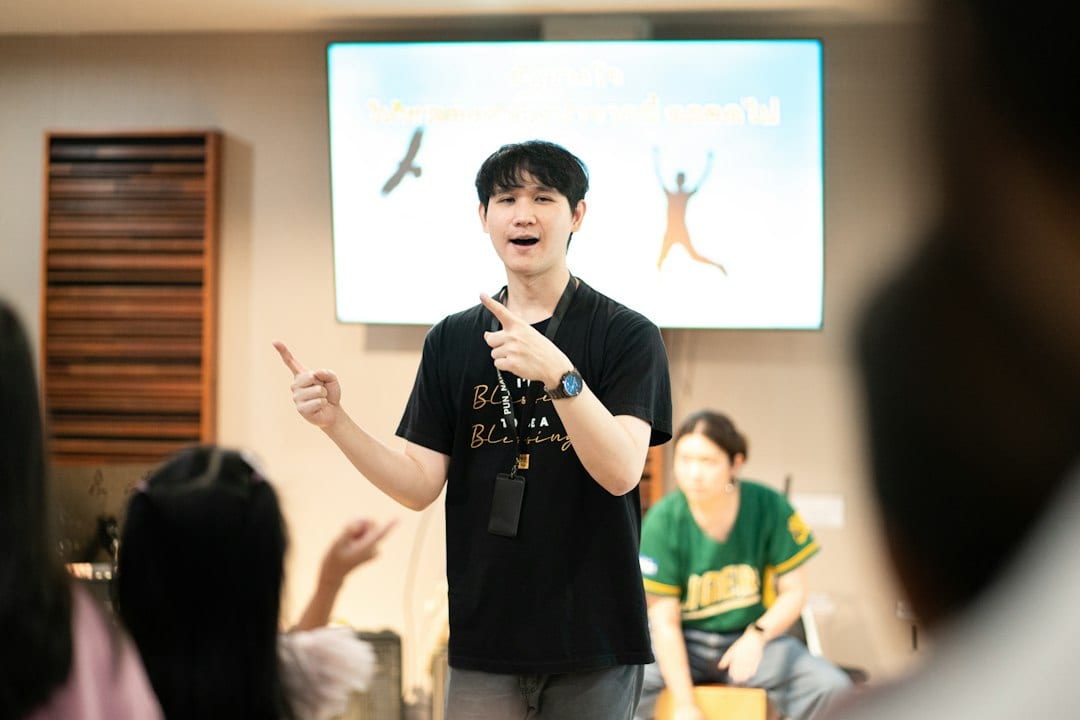 A man gestures enthusiastically while presenting to an audience